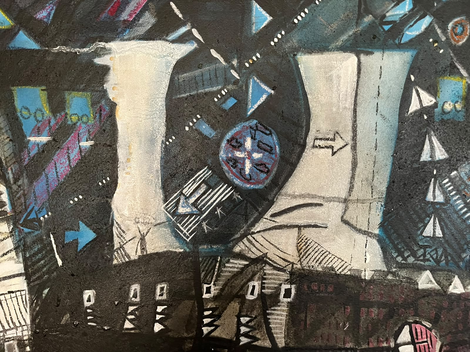 Detail — pale towers and a clock-like wheel in blue night